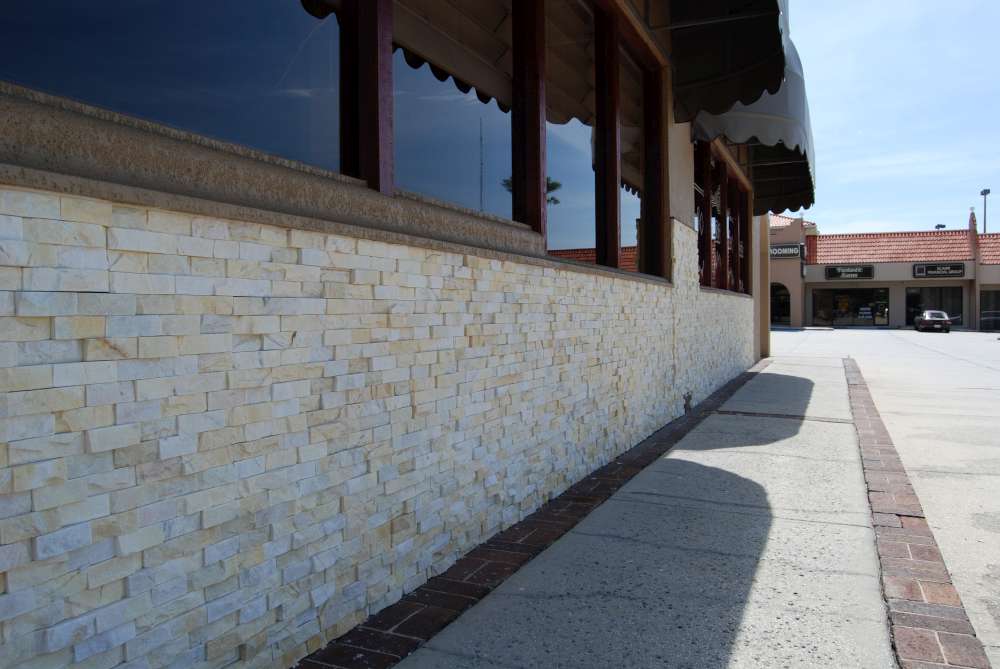 Stone veneer installed over an EIFS System on a commercial restaurant project with stucco above the stone